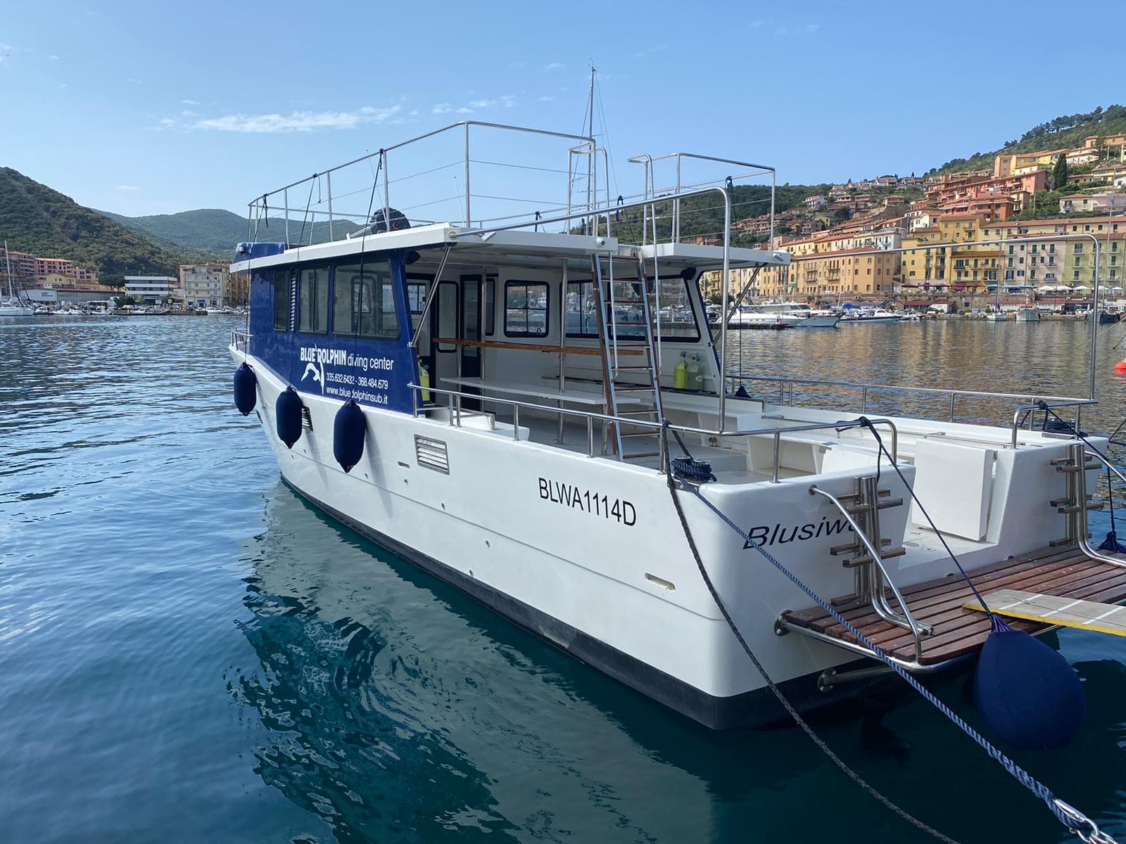 La barca del diving ormeggiata nel porto di Porto Santo Stefano